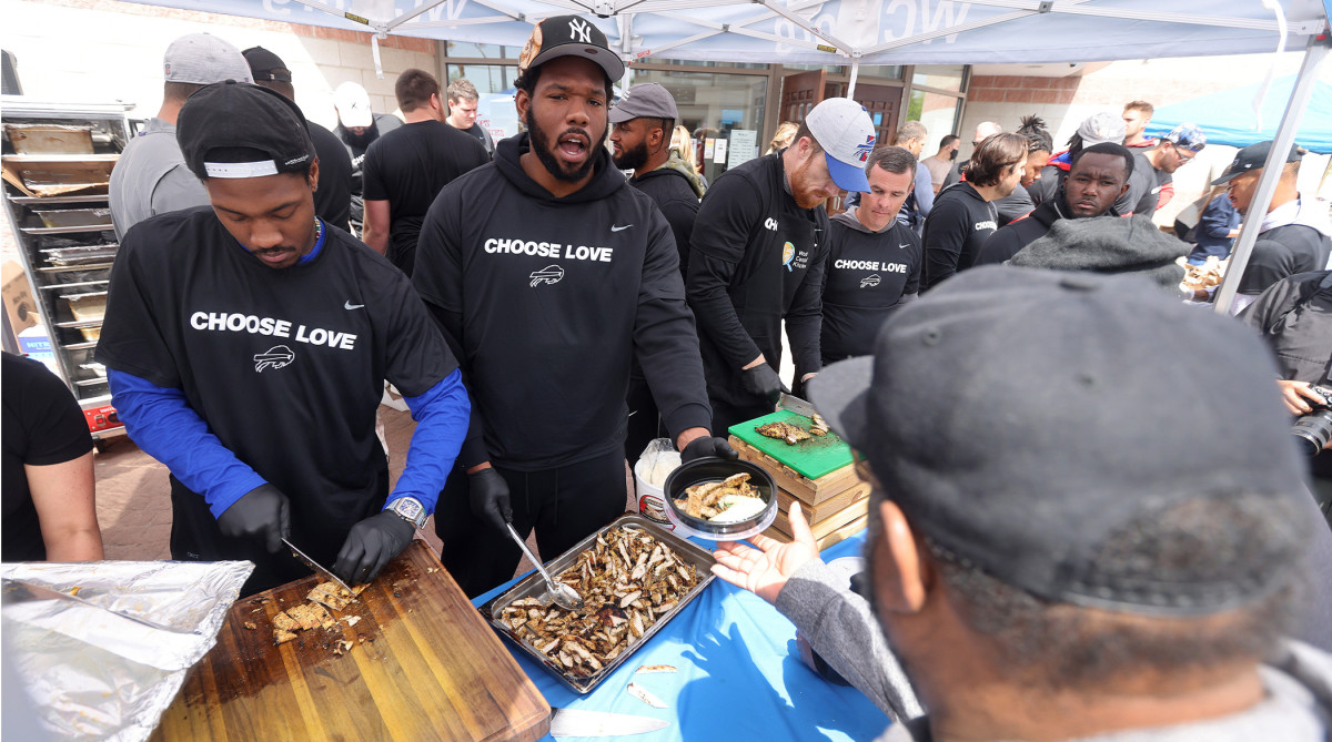 Buffalo Bills players visited the site near Tops Market in Buffalo to distribute food to members of the community.