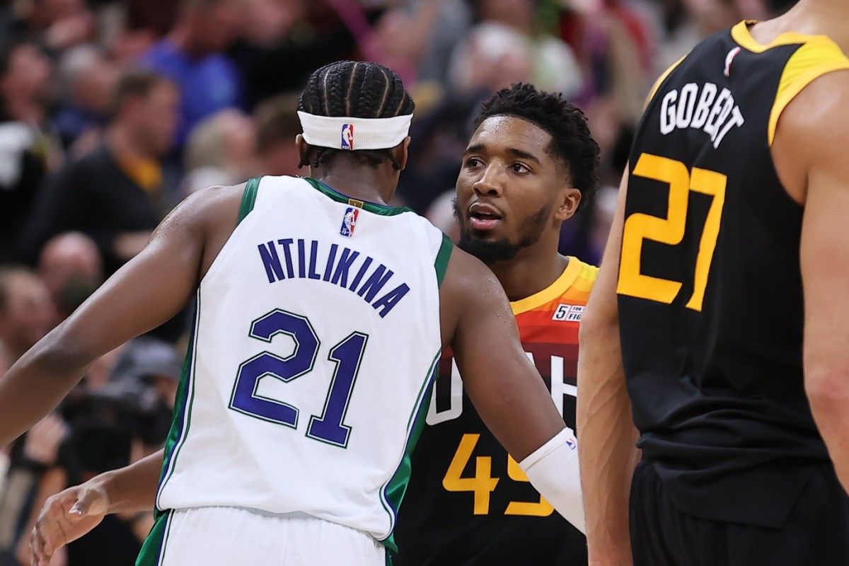 Dallas Mavericks guard Frank Ntilikina (21) and Utah Jazz guard Donovan Mitchell (45) react to the end of the game at Vivint Arena.