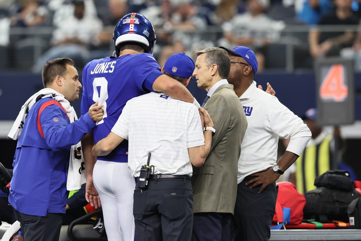 Oct 10, 2021; Arlington, Texas, USA; New York Giants quarterback Daniel Jones (8) is helped onto the cart after an injury in the second quarter against the Dallas Cowboys at AT&T Stadium.
