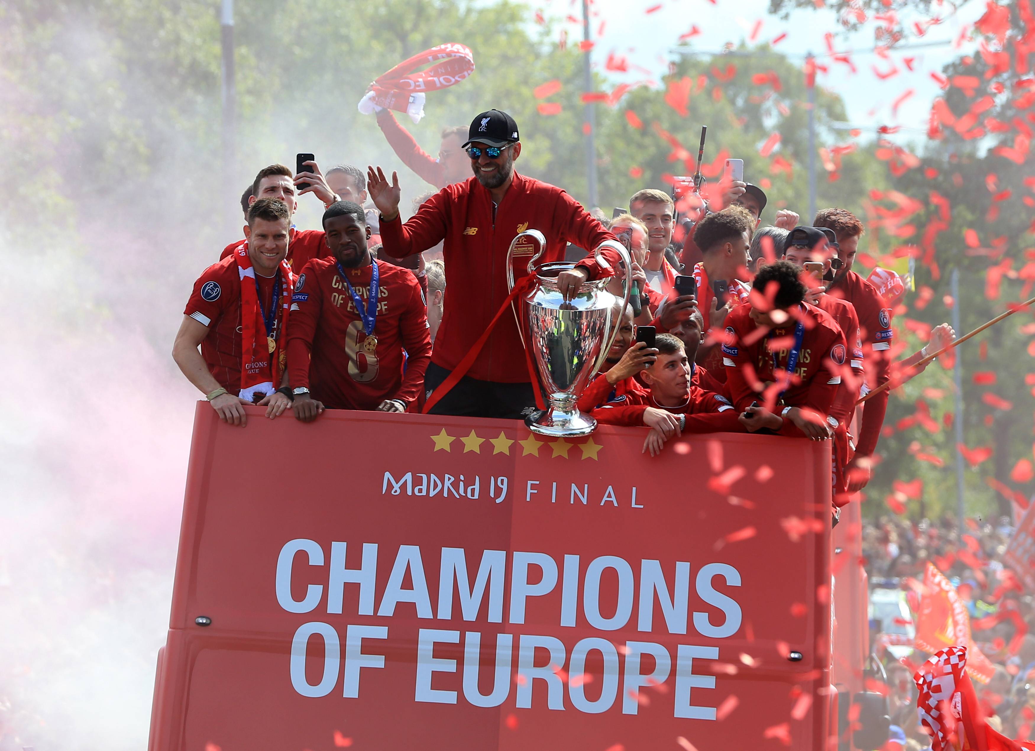 Liverpool manager Jurgen Klopp pictured holding the Champions League trophy during an open-top bus parade in 2019