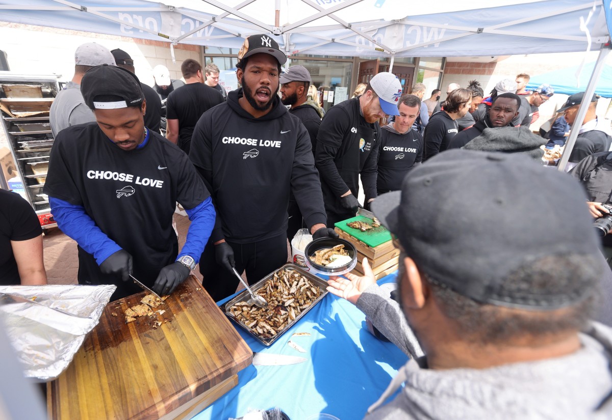 Buffalo Bills players visited the site near Tops Market in Buffalo to distribute food to members of the community.