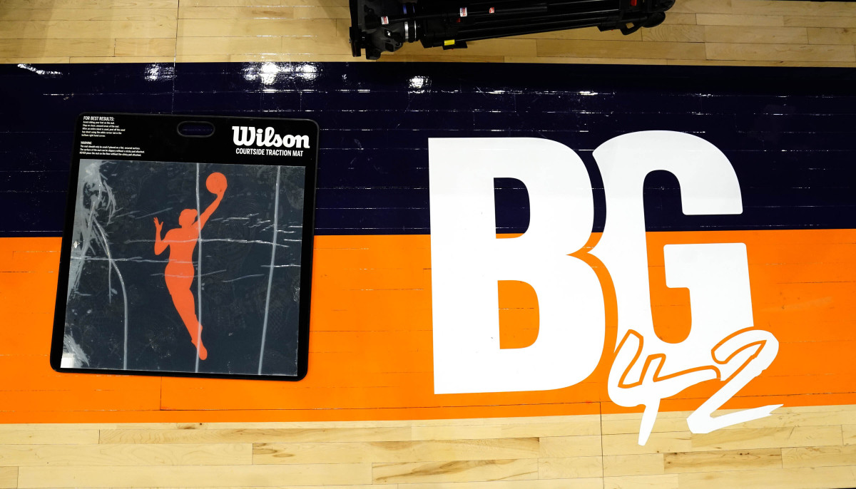 A floor decal in front of the scorer’s table pays tribute to Phoenix Mercury’s Brittney Griner before a WNBA basketball game between the Mercury and the Las Vegas Aces, Friday, May 6, 2022, in Phoenix. Griner has been detained in Russia since Feb. 17 after authorities at the Moscow airport said they found vape cartridges that allegedly contained oil derived from cannabis in her luggage.