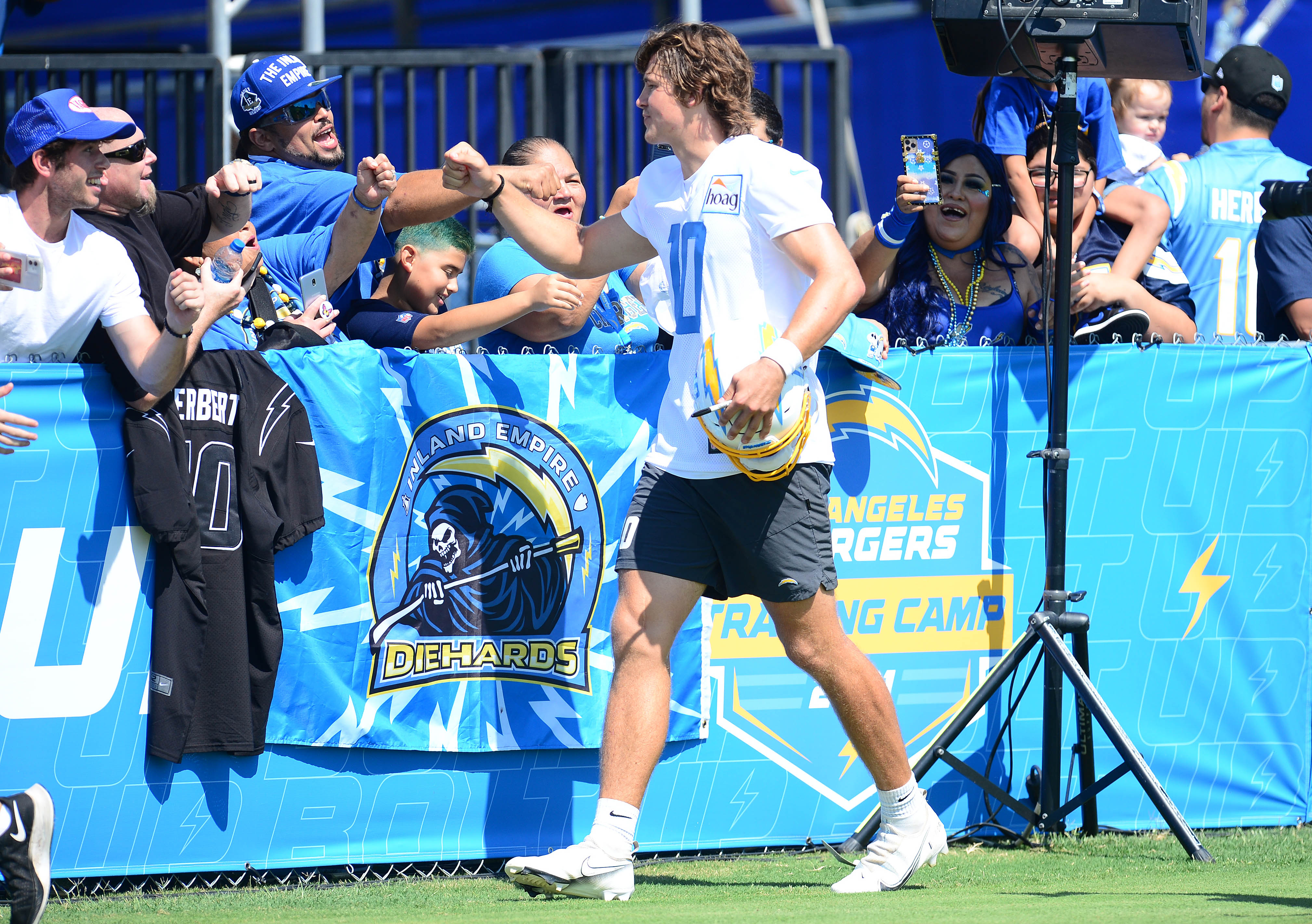 Jul 28, 2021; Costa Mesa, CA, United States; Los Angeles Chargers quarterback Justin Herbert (10) meets with fans following training camp at Jack Hammett Sports Complex. Mandatory Credit: Gary A. Vasquez-USA TODAY Sports