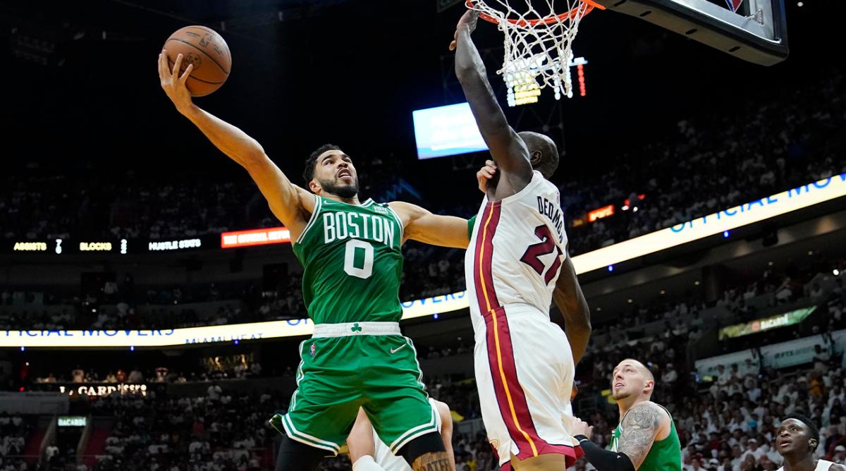 Boston Celtics forward Jayson Tatum (0) drives to the basket as Miami Heat center Dewayne Dedmon (21) defends during the first half of Game 1 of an NBA basketball Eastern Conference finals playoff series, Tuesday, May 17, 2022, in Miami.