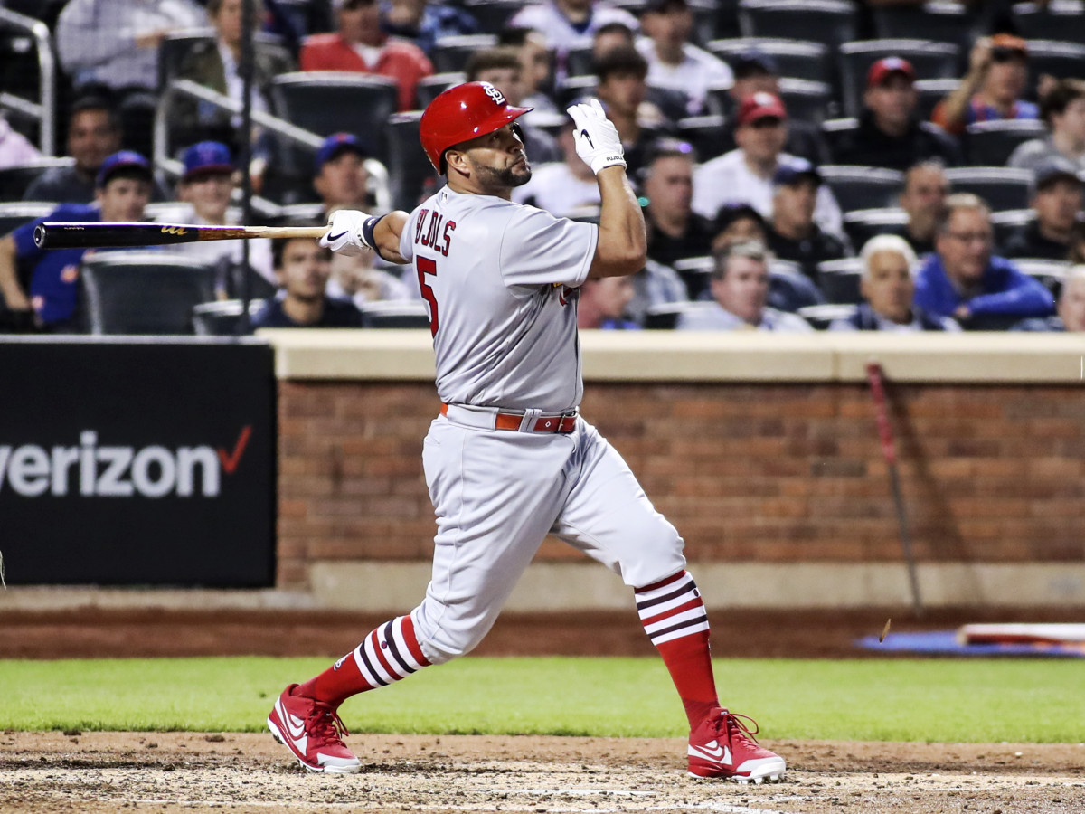 May 18, 2022; New York City, New York, USA;  St. Louis Cardinals designated hitter Albert Pujols (5) hits a single in the fourth inning against the New York Mets at Citi Field.