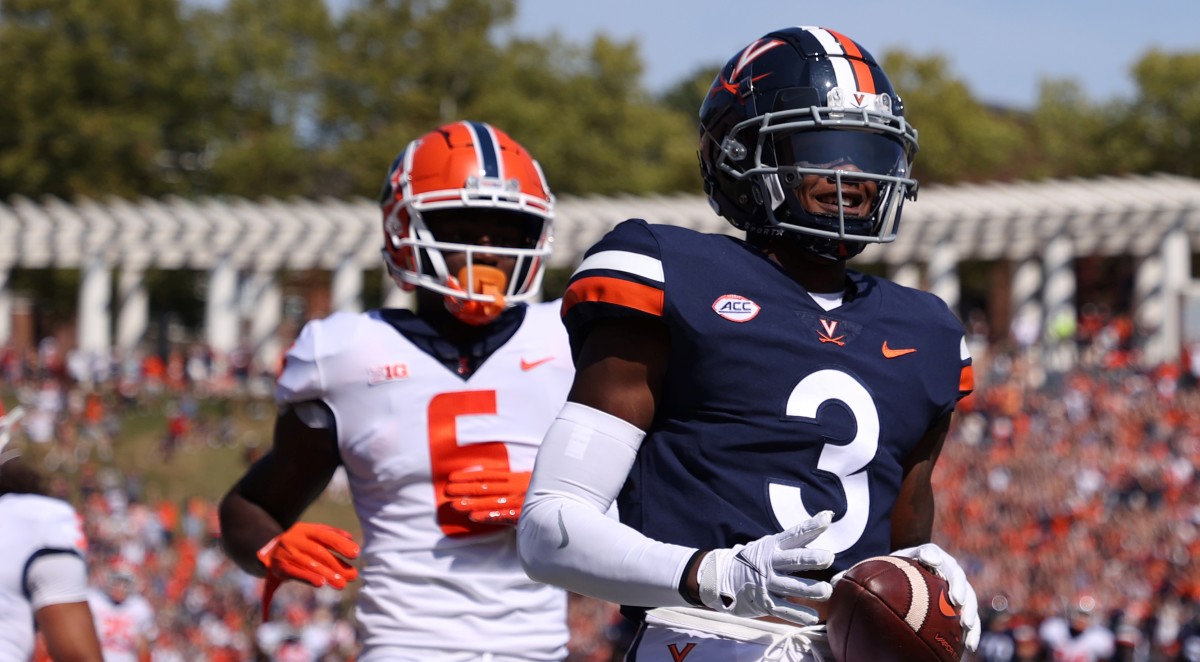 Virginia Cavaliers wide receiver Dontayvion Wicks (3) scores a touchdown as Illinois Fighting Illini defensive back Tony Adams (6) watches in the first quarter at Scott Stadium.