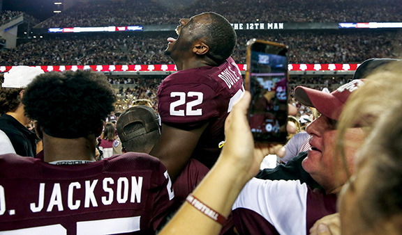 Texas A&M Aggies linebacker Antonio Doyle Jr. (22) laughs as Texas A&M Aggies and fans rush the field after beating the Alabama Crimson Tide on a last second field in the fourth quarter at Kyle Field.