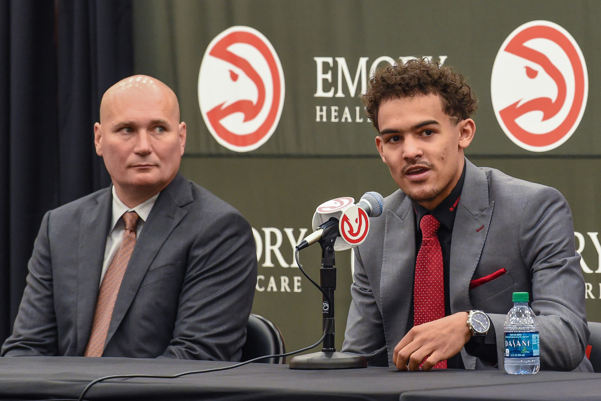 Atlanta Hawks general manager Travis Schlenk (left) listens as draft pick Trae Young answers a question during a press conference at Atlanta Hawks Emory Sports Medicine Complex.