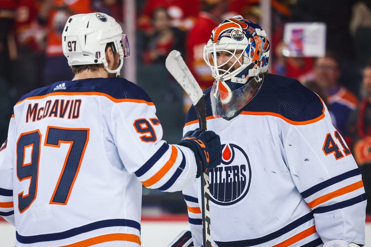 May 20, 2022; Calgary, Alberta, CAN; Edmonton Oilers goaltender Mike Smith (41) celebrate win with center Connor McDavid (97) against the Calgary Flames in game two of the second round of the 2022 Stanley Cup Playoffs at Scotiabank Saddledome. Mandatory Credit: Sergei Belski-USA TODAY Sports