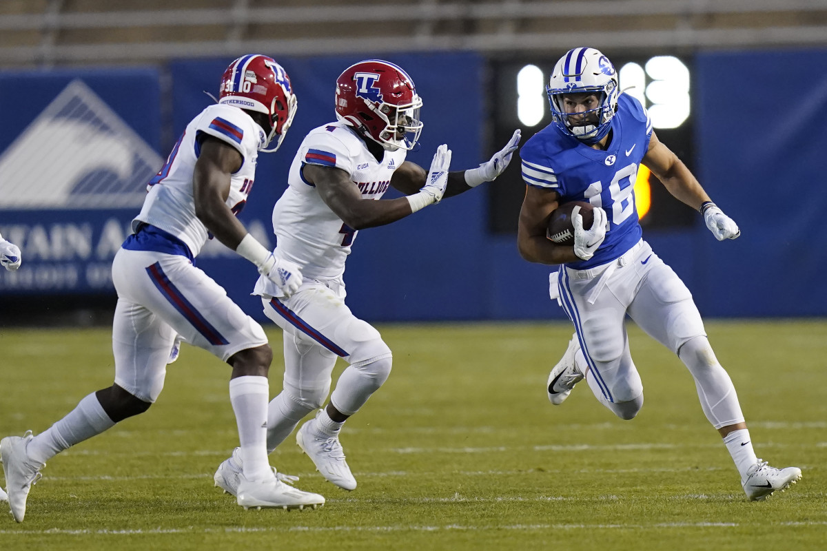Oct 2, 2020; Provo, UT, USA; BYU wide receiver Gunner Romney (18) carries the ball as Louisiana Tech s Bee Jay Williamson, center, and Cedric Woods, left, move in for the tackle in the first half during an NCAA college football game Friday, Oct. 2, 2020, in Provo, Utah. Mandatory Credit: Rick Bowmer/Pool Photo-USA TODAY Sports