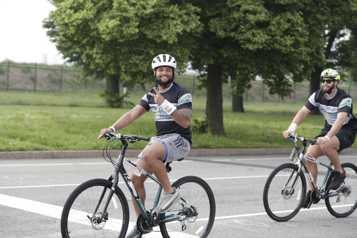 Avonte Maddox (left) and Dallas Goedert participate in Eagles Autism Challenge on May 21, 2022