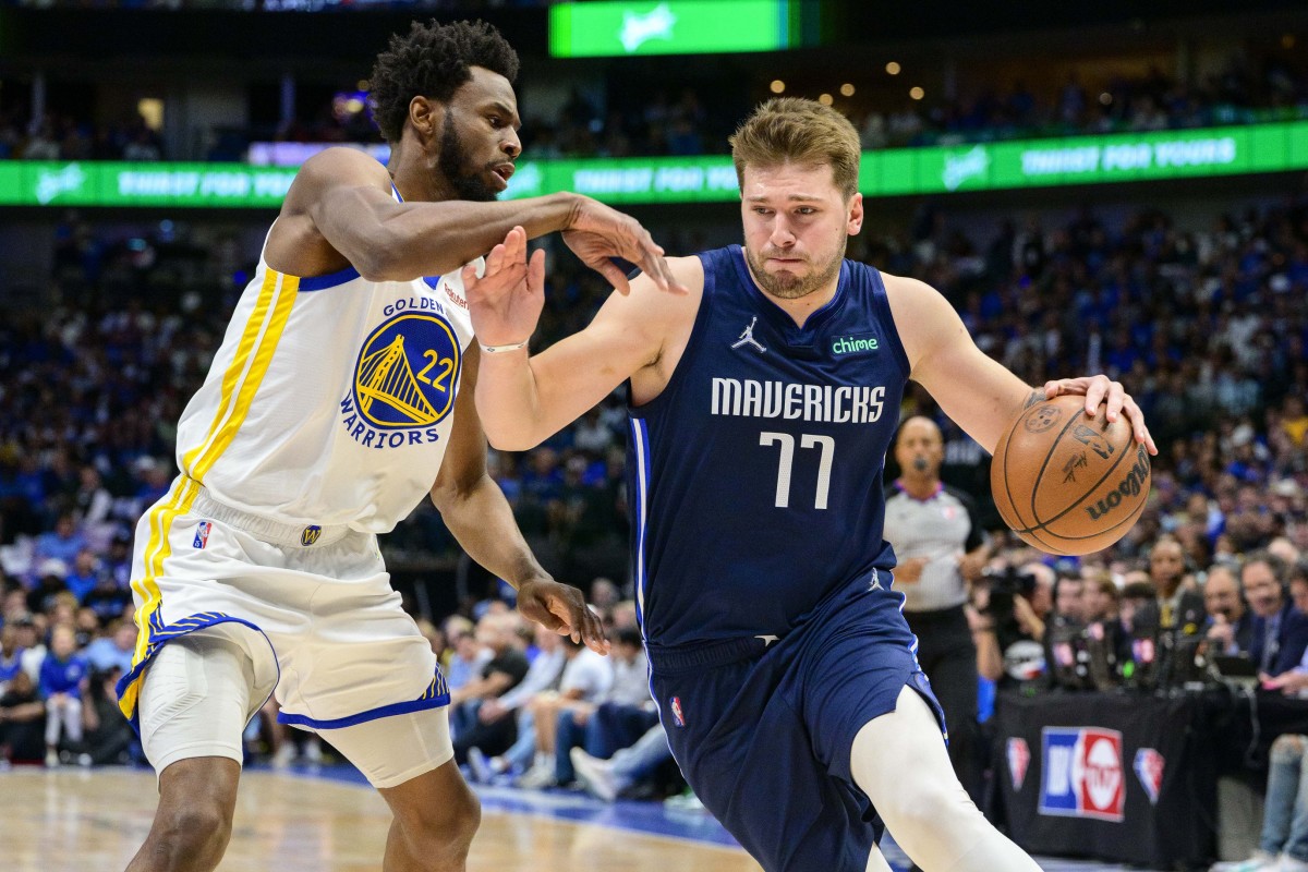 May 22, 2022; Dallas, Texas, USA; Dallas Mavericks guard Luka Doncic (77) brings the ball up court past Golden State Warriors forward Andrew Wiggins (22) during the first quarter in game three of the 2022 western conference finals at American Airlines Center. Mandatory Credit: Jerome Miron-USA TODAY Sports