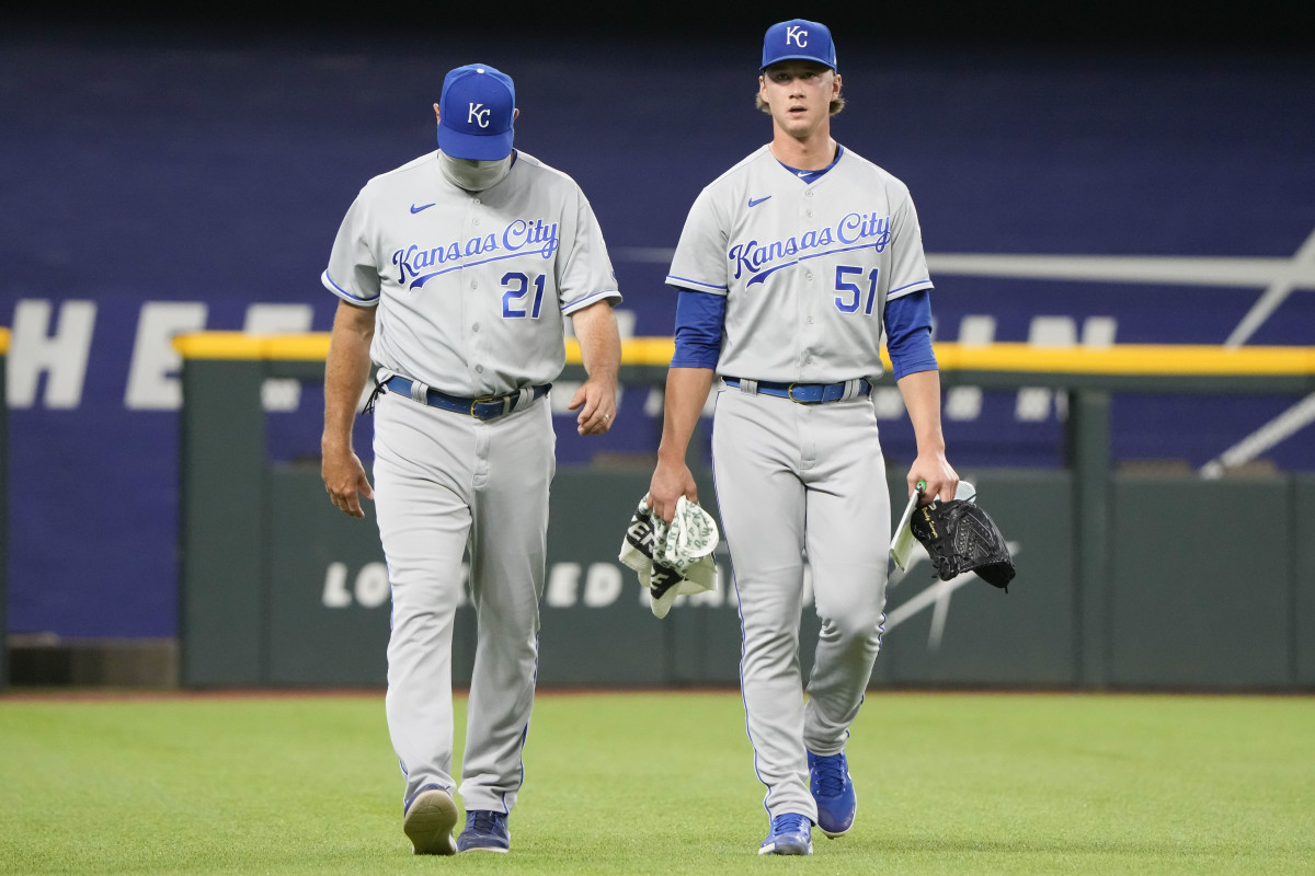 Jun 27, 2021; Arlington, Texas, USA; Kansas City Royals starting pitcher Brady Singer (51) and pitching coach Cal Eldred (21) walk to the dugout before the start of a baseball game against the Texas Rangers at Globe Life Field. Mandatory Credit: Jim Cowsert-USA TODAY Sports