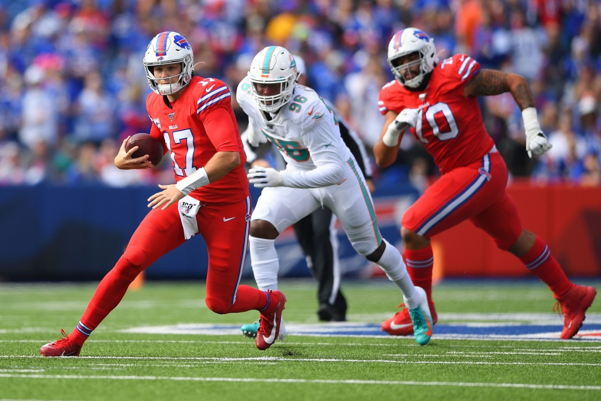 Oct 20, 2019; Buffalo Bills quarterback Josh Allen (17) scrambles in front of Miami Dolphins defensive end Taco Charlton (96). Mandatory Credit: Rich Barnes-USA TODAY