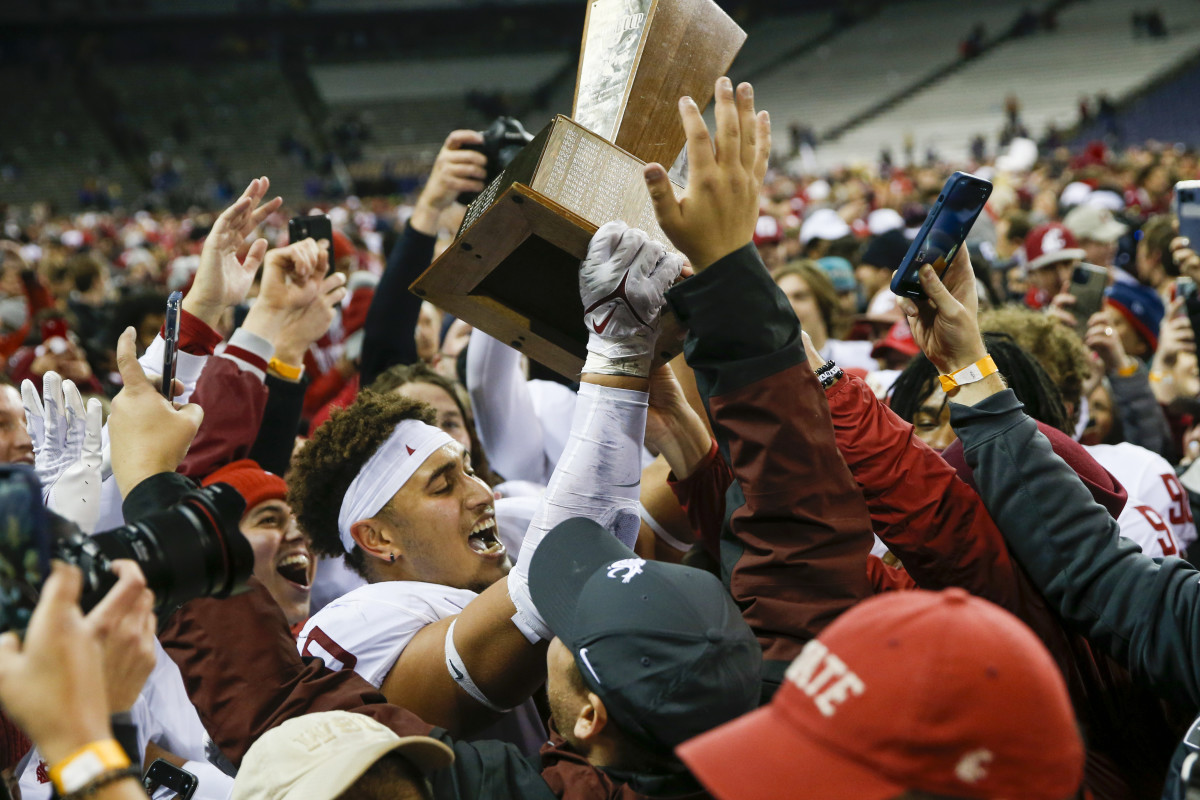 Washington State players lift the Apple Cup