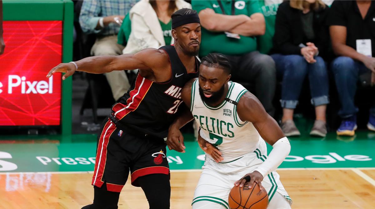 Boston Celtics’ Jaylen Brown (7) drives past Miami Heat’s Jimmy Butler (22) during the first half of Game 3 of the NBA basketball playoffs Eastern Conference finals Saturday, May 21, 2022, in Boston.