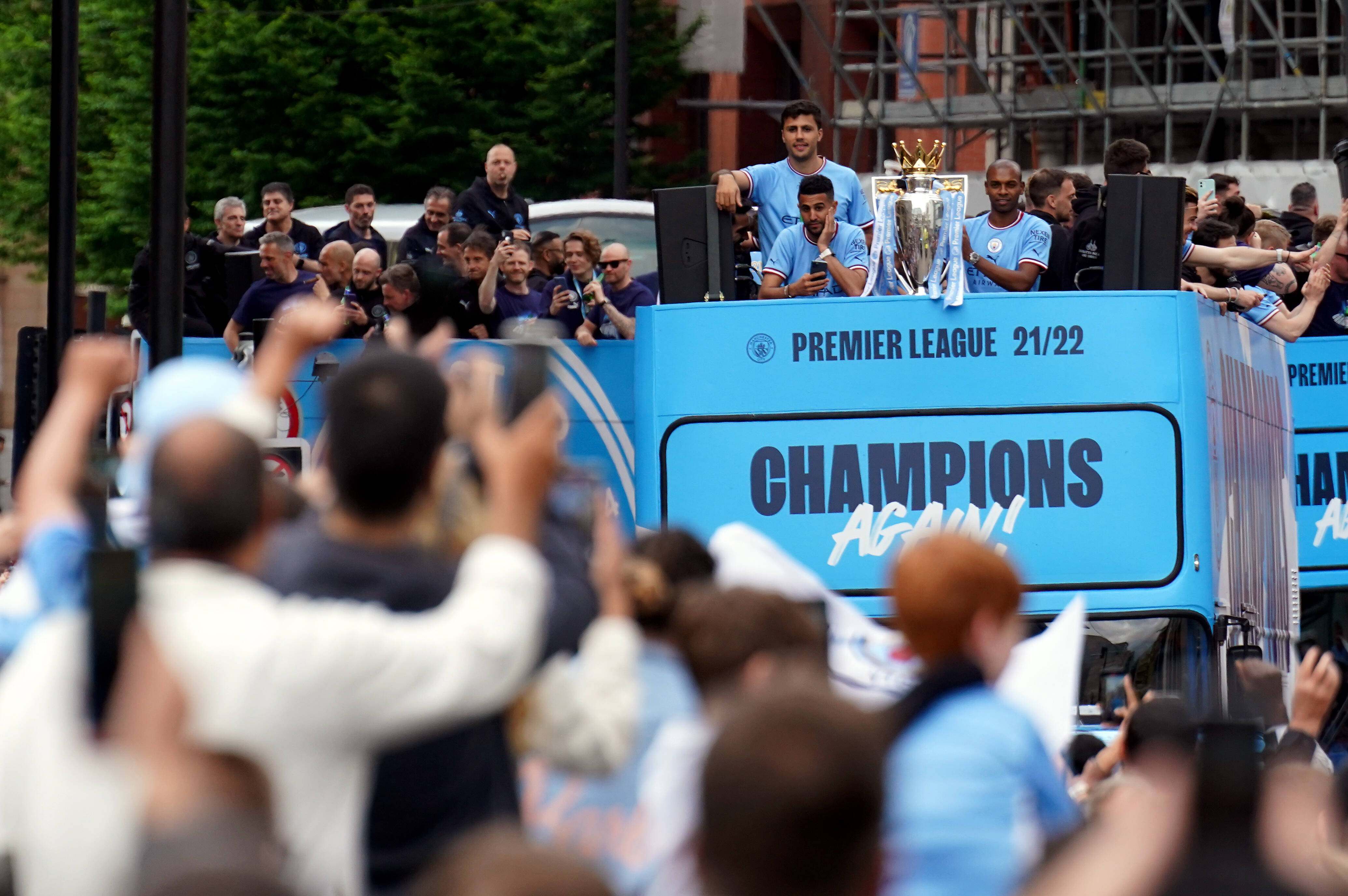 Manchester City's players pictured parading their Premier League trophy from an open-top bus 24 hours after winning it on the final day of the 2021/22 season