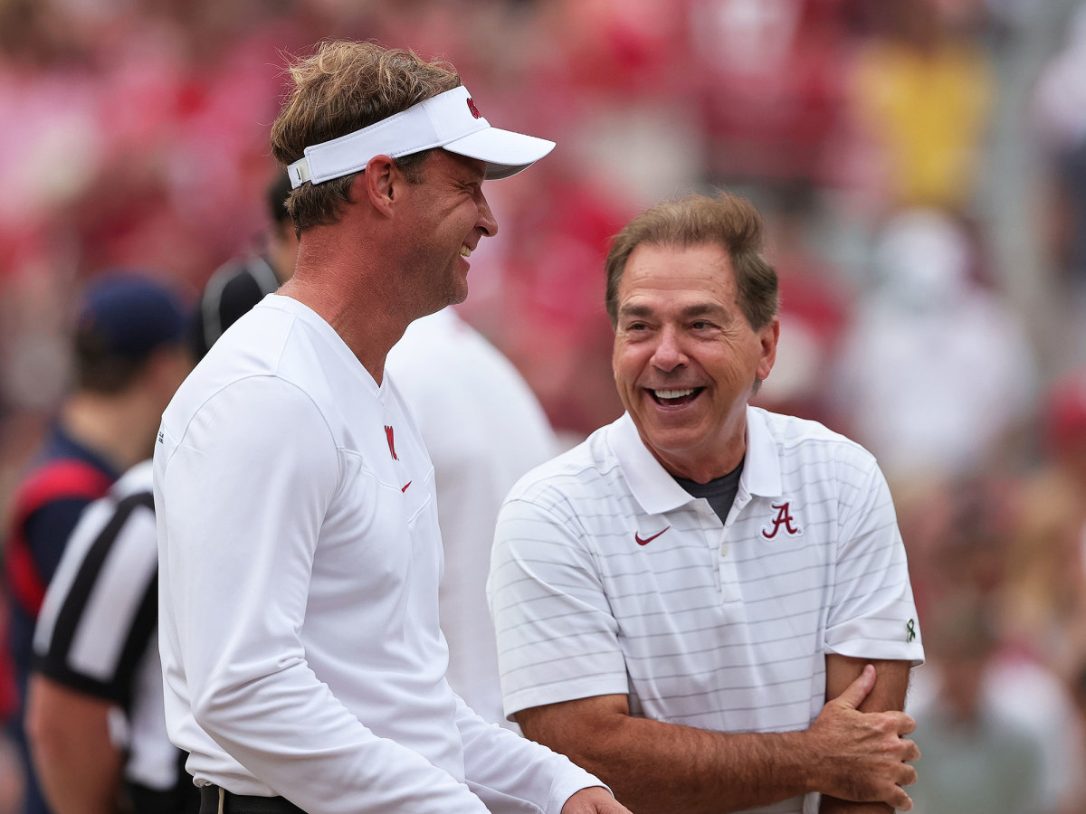 Lane Kiffin and Nick Saban laugh before a game