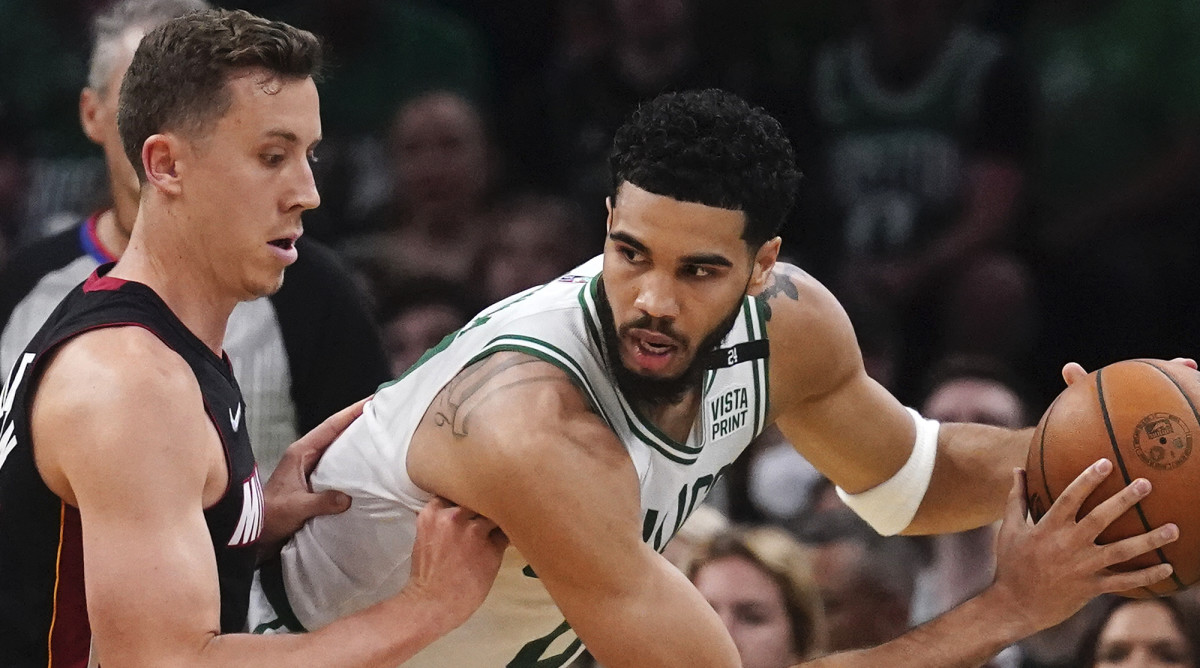 Boston Celtics forward Jayson Tatum, right, prepares to drive against Miami Heat guard Duncan Robinson, left, during the first half of Game 4 of the NBA basketball playoffs Eastern Conference finals, Monday, May 23, 2022, in Boston.