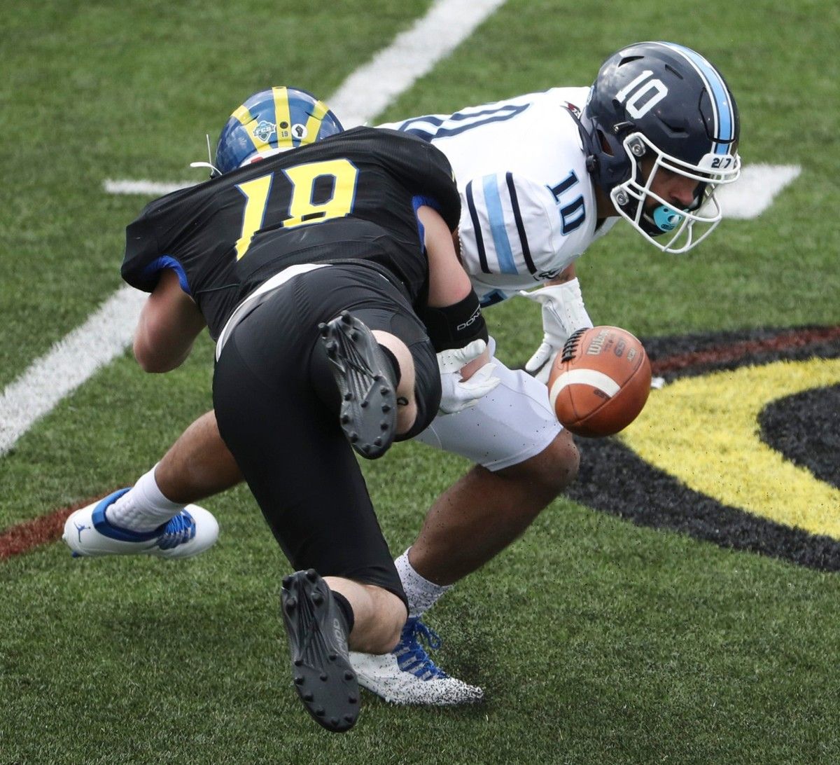Delaware linebacker Matt Palmer disrupts a pitch reception by Maine's Andre Miller, foiling a Black Bear fourth down bid in the second half of the Blue Hens' 37-0 win at Delaware Stadium, Saturday, March 6, 2021.