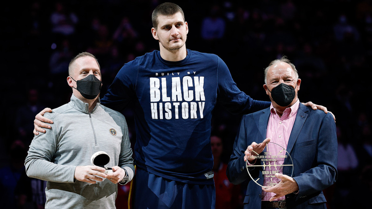 Denver Nuggets center Nikola Jokic (C) is presented with an NBA All-Star ring from Nuggets president Tim Connelly.