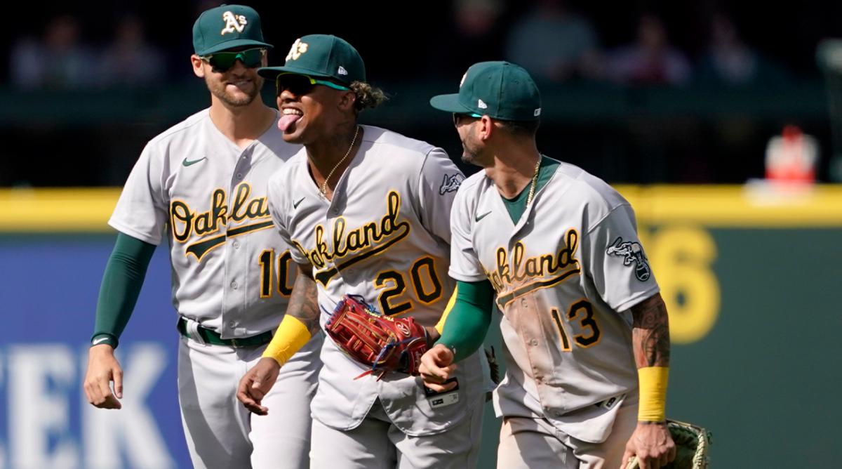 Oakland Athletics outfielders Chad Pinder (10), Cristian Pache (20) and Luis Barrera (13) head off the field after the Athletics defeated the Seattle Mariners 4-2 in a baseball game Wednesday, May 25, 2022, in Seattle.