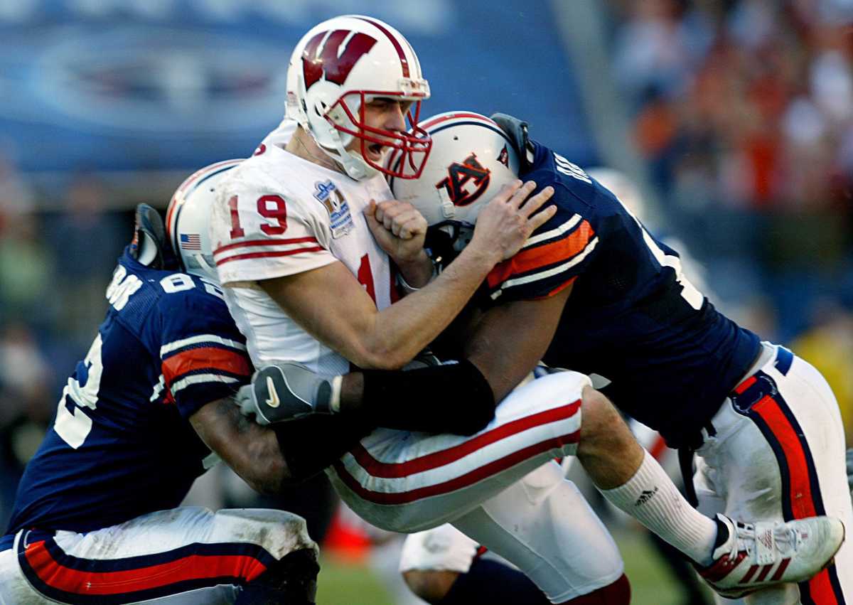 Wisconsin quarterback Jim Sorgi (19) gets sandwiched by Auburn defenders Reggie Torbor and Karlos Dansby, causing him to fumble in the fourth quarter. Auburn defeated Wisconsin 28-14 before 55,109 in the Music City Bowl in Nashville Dec. 31, 2003. Music City Bowl
