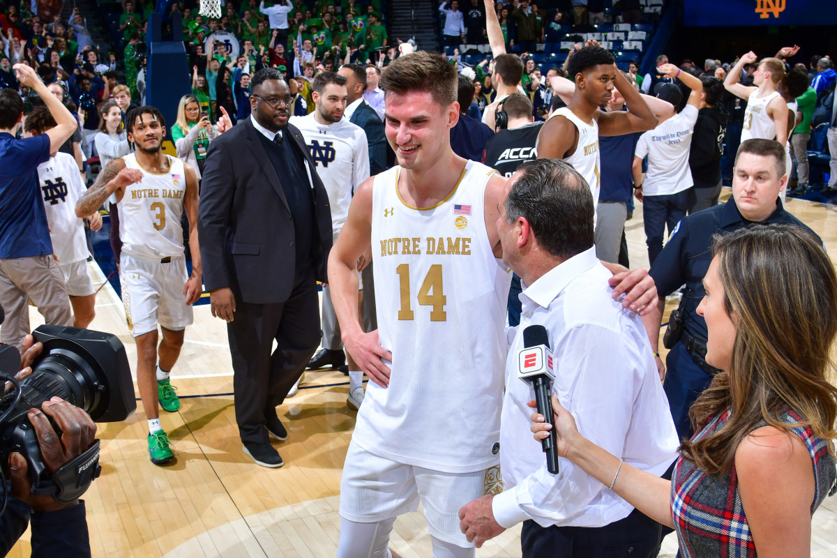 Notre Dame Fighting Irish head coach Mike Brey and forward Nate Laszewski (14) do a television interview following the win over the North Carolina Tar Heels at the Purcell Pavilion.