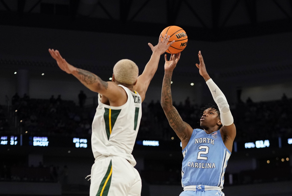 North Carolina Tar Heels guard Caleb Love (2) shoots over Baylor Bears forward Jeremy Sochan (1) during the second round of the 2022 NCAA Tournament at Dickies Arena.