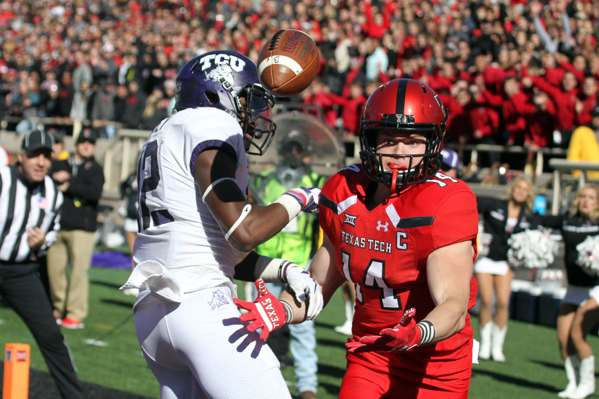 Nov 18, 2017; Lubbock, TX, USA; Texas Tech Red Raiders wide receiver Dylan Cantrell (14) watches the ball bounce off TCU Horned Frogs defensive back Jeff Gladney (12) in the second half at Jones AT&T Stadium.