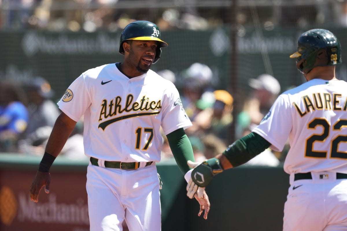 May 29, 2022; Oakland, California, USA; Oakland Athletics shortstop Elvis Andrus (17) celebrates with right fielder Ramon Laureano (22) after scoring a run against the Texas Rangers during the fifth inning at RingCentral Coliseum. Mandatory Credit: Darren Yamashita-USA TODAY Sports