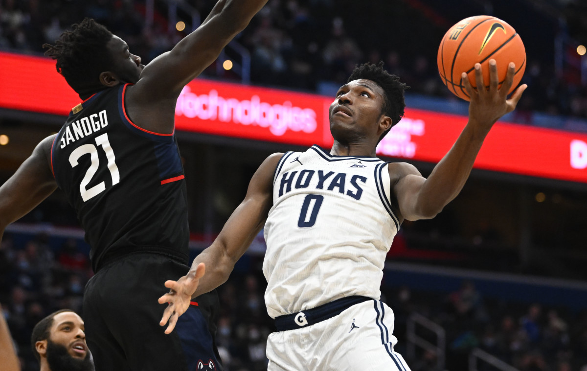 Georgetown Hoyas guard Aminu Mohammed (0) shoots over Connecticut Huskies forward Adama Sanogo (21) during the first half at Capital One Arena.