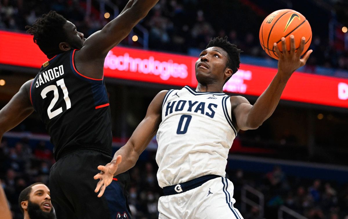 Georgetown Hoyas guard Aminu Mohammed (0) shoots over Connecticut Huskies forward Adama Sanogo (21) during the first half at Capital One Arena.
