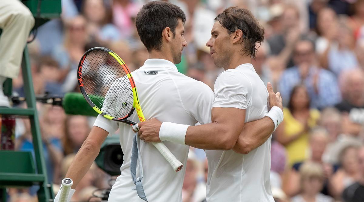 Jul 14, 2018; London, United Kingdom; Novak Djokovic (SRB) and Rafael Nadal (ESP) at the net after their match on day 12 at All England Lawn and Croquet Club.