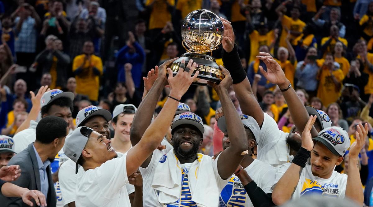 Golden State Warriors celebrate with the conference trophy after defeating the Dallas Mavericks in Game 5 of the NBA basketball playoffs Western Conference finals in San Francisco, Thursday, May 26, 2022.