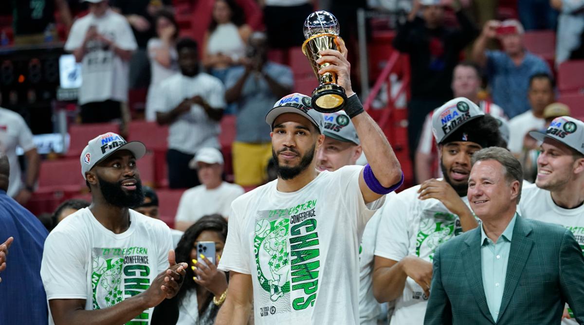 Boston Celtics forward Jayson Tatum raises the NBA Eastern Conference MVP trophy after defeating the Miami Heat in Game 7 of the NBA basketball Eastern Conference finals playoff series, Sunday, May 29, 2022, in Miami.