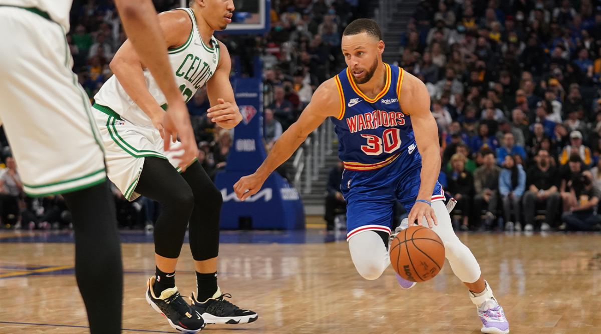 Mar 16, 2022; San Francisco, California, USA; Golden State Warriors guard Stephen Curry (30) dribbles past Boston Celtics forward Grant Williams (12) in the second quarter at the Chase Center.