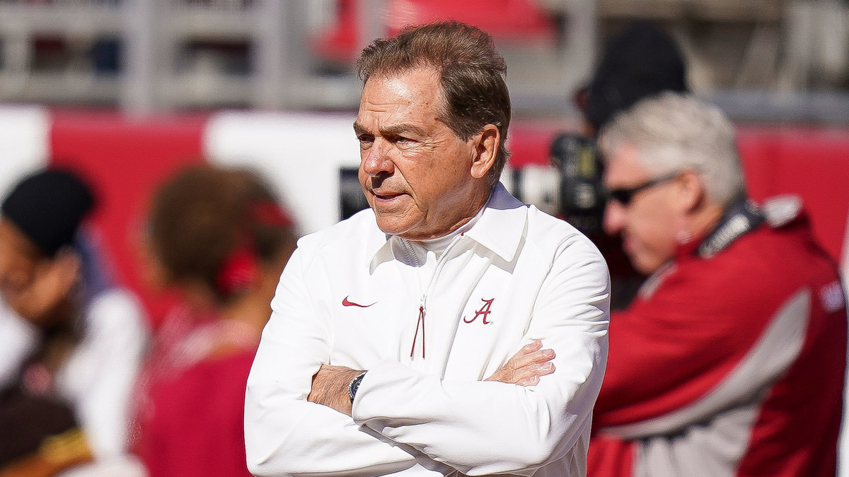 Nick Saban folds his arms during a game