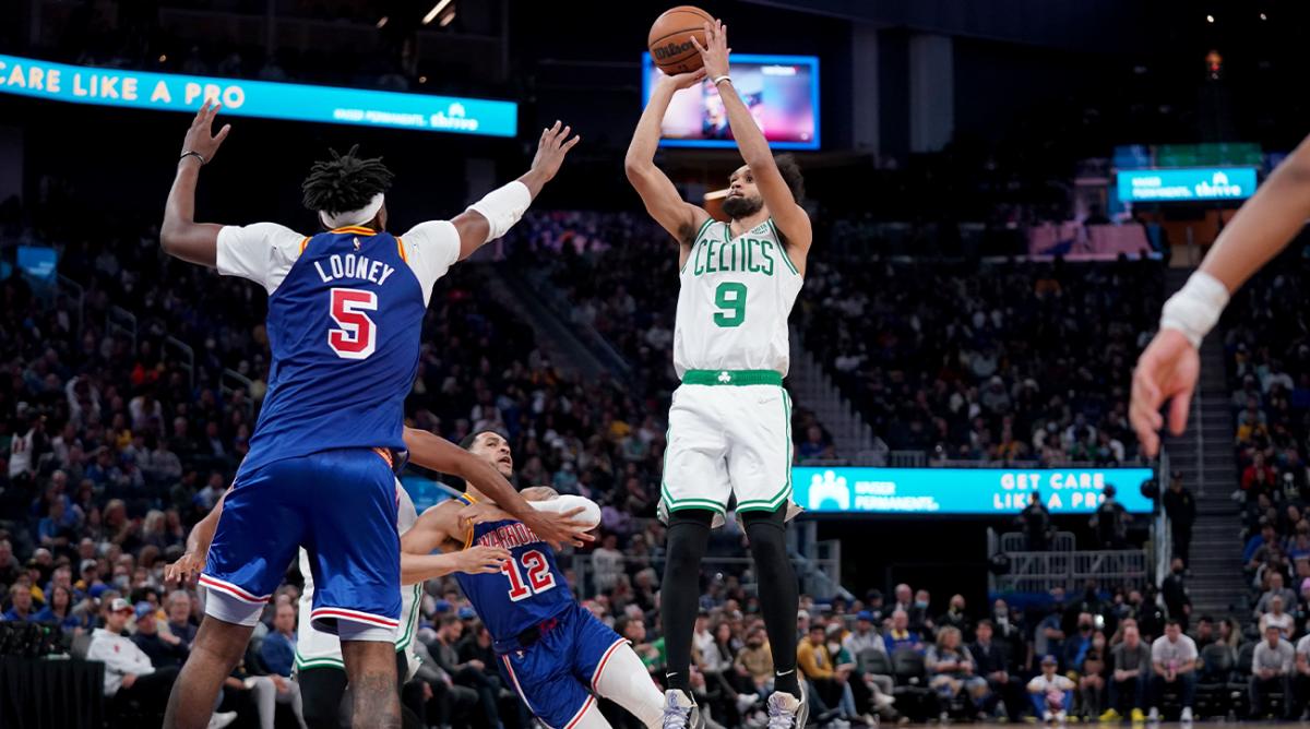 Mar 16, 2022; San Francisco, California, USA; Boston Celtics guard Derrick White (9) shoots the ball over Golden State Warriors forward Kevon Looney (5) in the third quarter at the Chase Center.