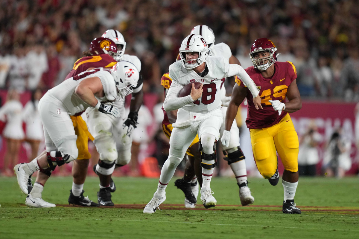 Stanford Cardinal quarterback Tanner McKee (18) carries the ball against the Southern California Trojans in the first half at United Airlines Field at Los Angeles Memorial Coliseum.