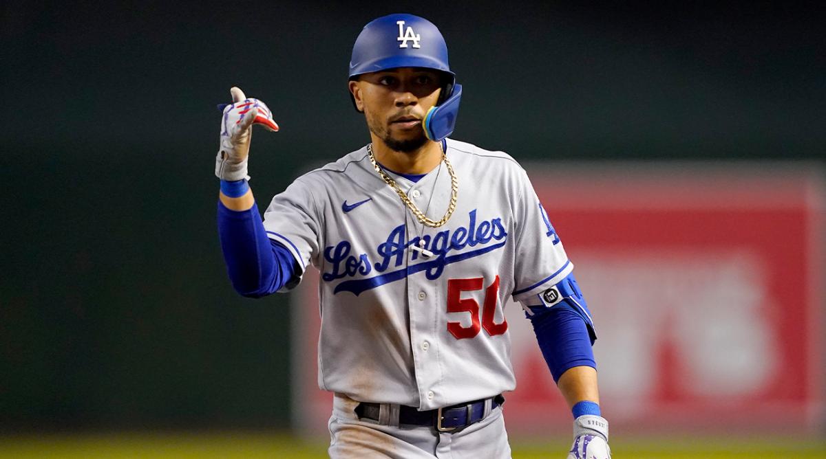 Los Angeles Dodgers’ Mookie Betts (50) motions to his dugout after a base hit against the Arizona Diamondbacks during the sixth inning of a baseball game, Thursday, May 26, 2022, in Phoenix.