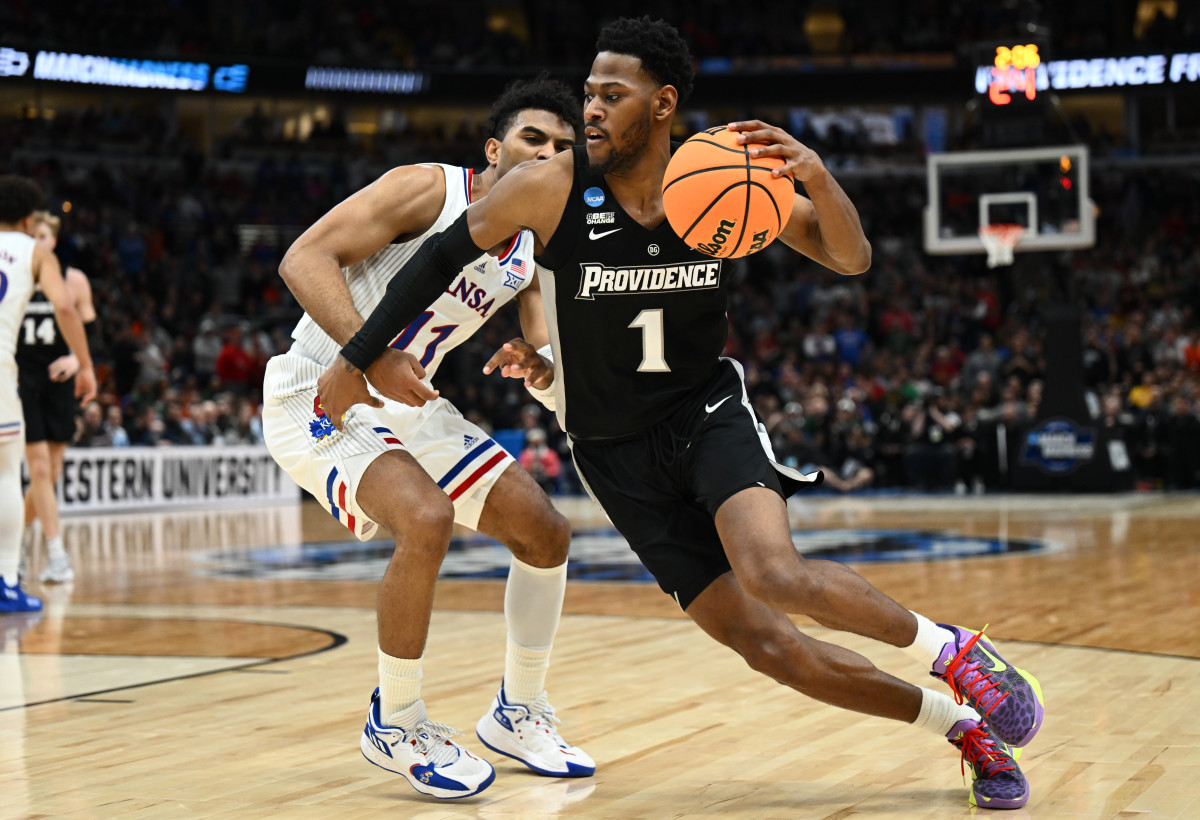Mar 25, 2022; Chicago, IL, USA; Providence Friars guard Al Durham (1) drives past Kansas Jayhawks guard Remy Martin (11) during the second half in the semifinals of the Midwest regional of the men's college basketball NCAA Tournament at United Center.