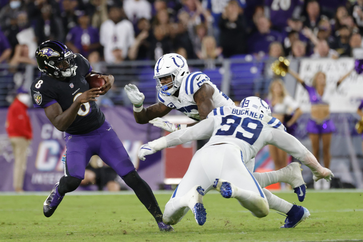 Oct 11, 2021; Baltimore, Maryland, USA; Baltimore Ravens quarterback Lamar Jackson (8) runs with the ball as Indianapolis Colts defensive tackle DeForest Buckner (99) and Colts outside linebacker Darius Leonard (53) chase during the third quarter at M&T Bank Stadium.