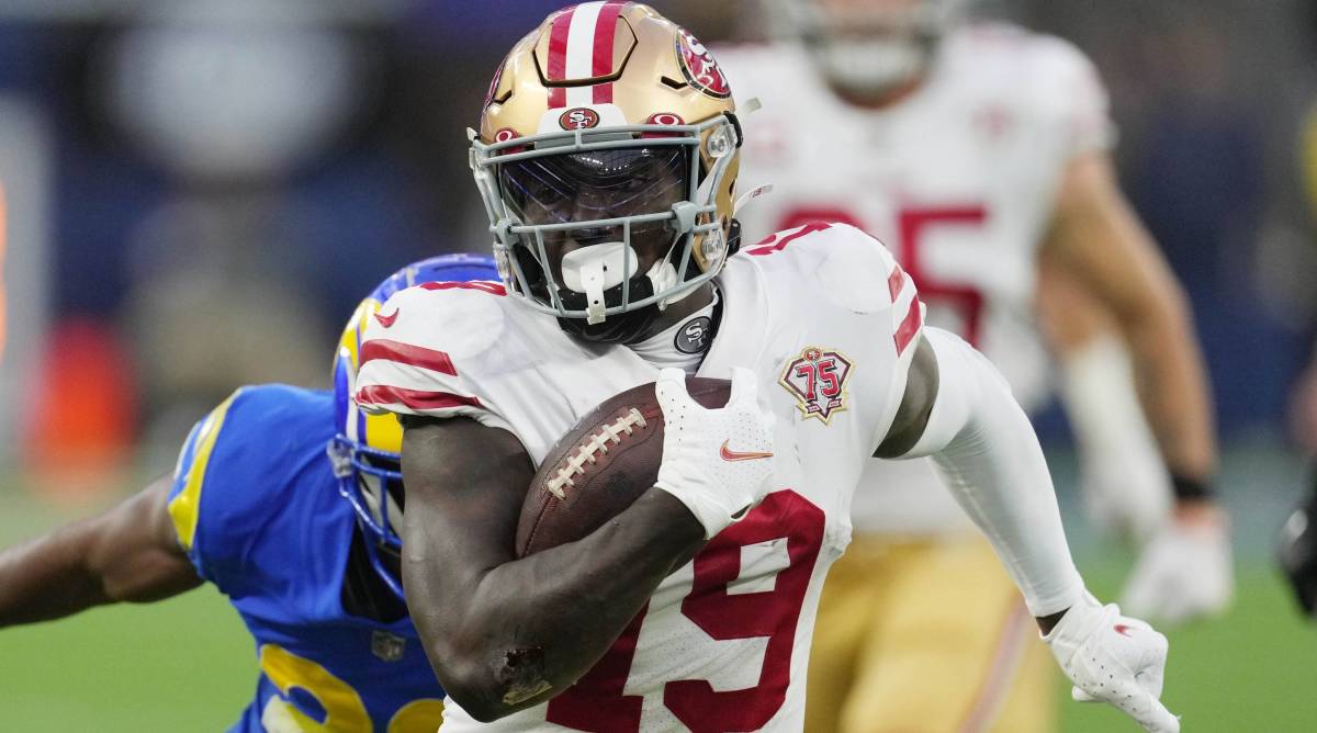 49ers wide receiver Deebo Samule runs away from a Rams defender.