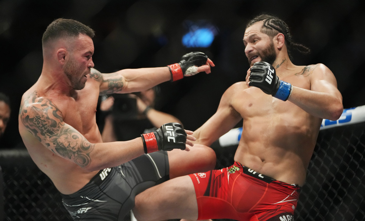 Colby Covington (red gloves) fights Jorge Masvidal (blue gloves) during UFC 272 at T-Mobile Arena.