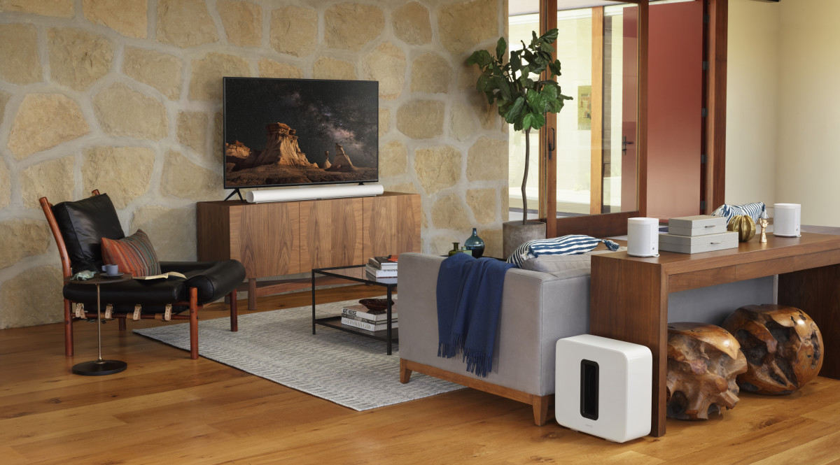 Pictured above is the Sonos Arc in white below a TV and the Sonos Sub on the floor.