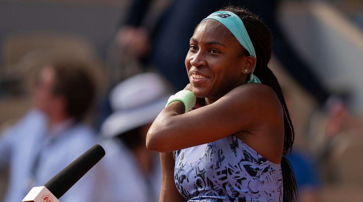 Coco Gauff speaking at a microphone at the French Open