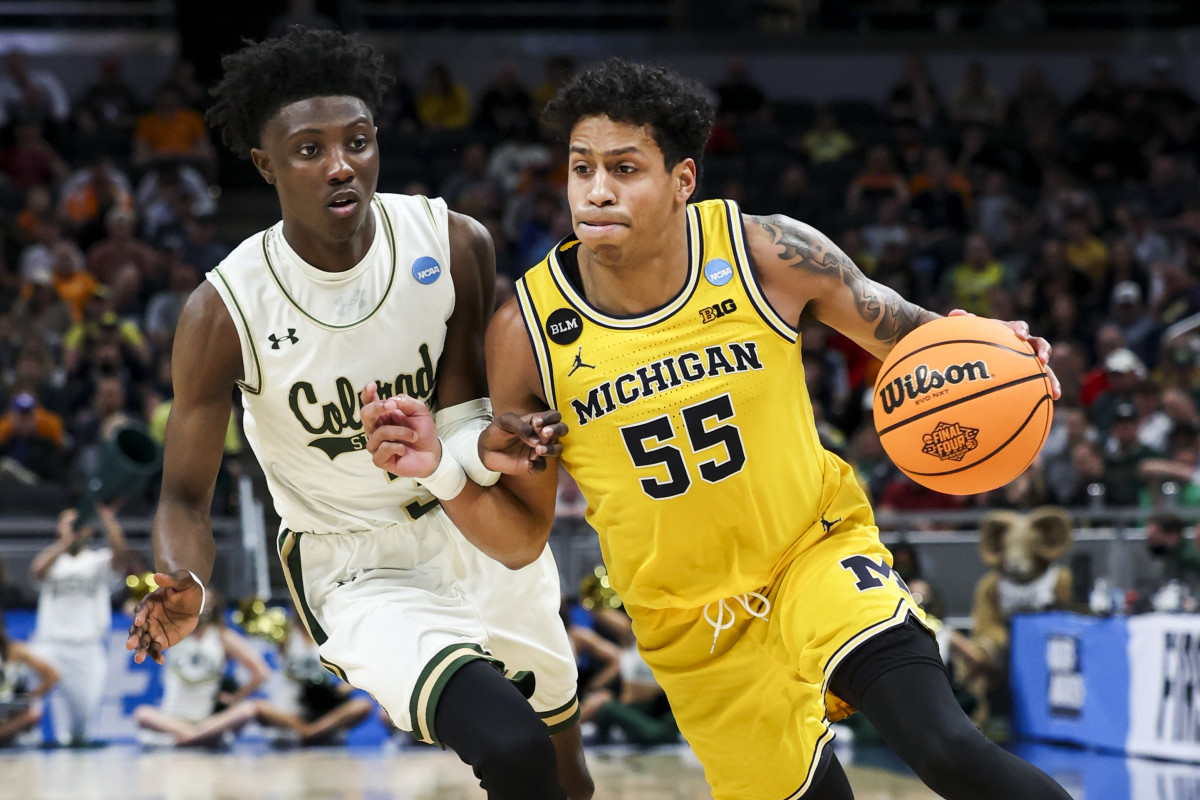 Michigan Wolverines guard Eli Brooks (55) controls the ball against Colorado State Rams guard Kendle Moore (3) in the second half during the first round of the 2022 NCAA Tournament at Gainbridge Fieldhouse.