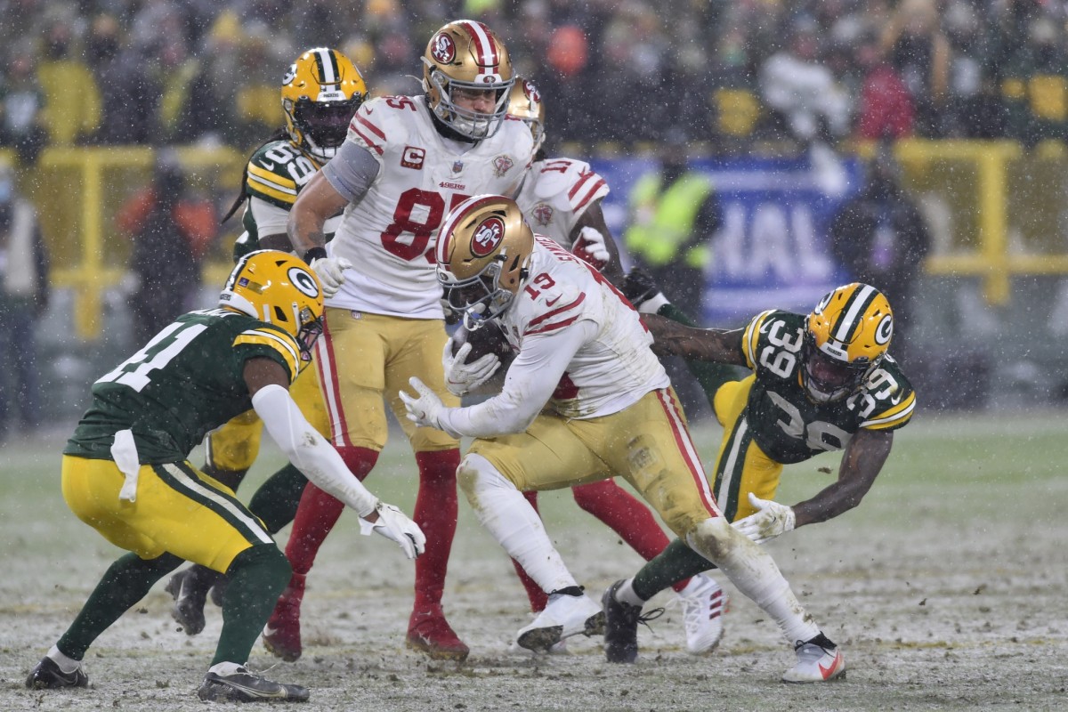 Jan 22, 2022; Green Bay, Wisconsin, USA; San Francisco 49ers wide receiver Deebo Samuel (19) and Green Bay Packers defensive back Chandon Sullivan (39) and safety Henry Black (41) in action during a NFC Divisional playoff football game at Lambeau Field.
