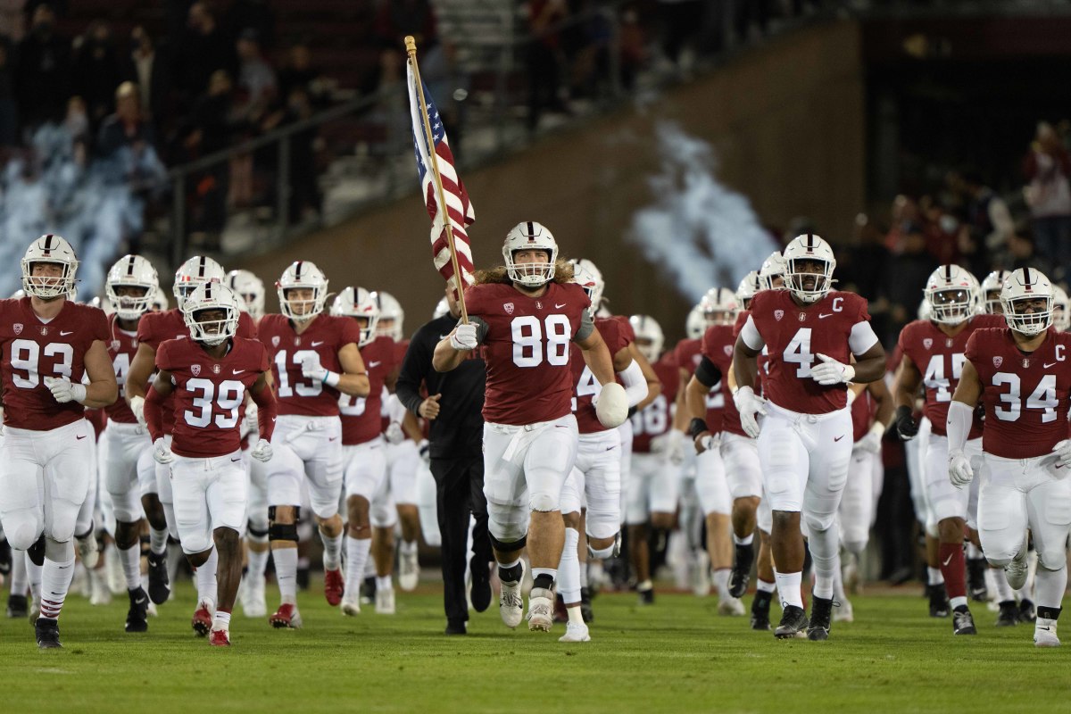Stanford Cardinal tight end Tucker Fisk (88) runs onto the field with his teammates waving the American flag before the game against the Utah Utes at Stanford Stadium. Mandatory Credit: